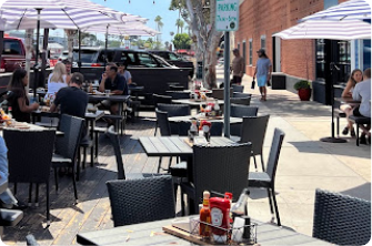 tables and chairs with the sun shining on them